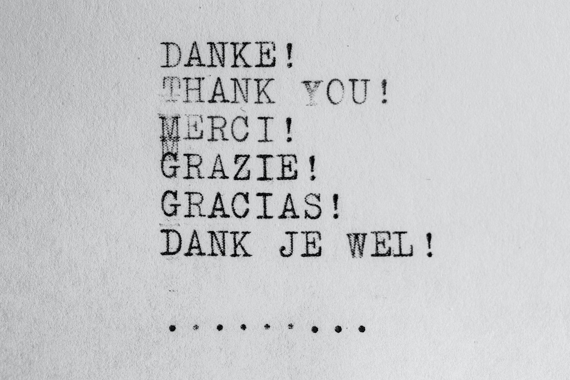 Grey rectangular card with thank you displayed in five different languages